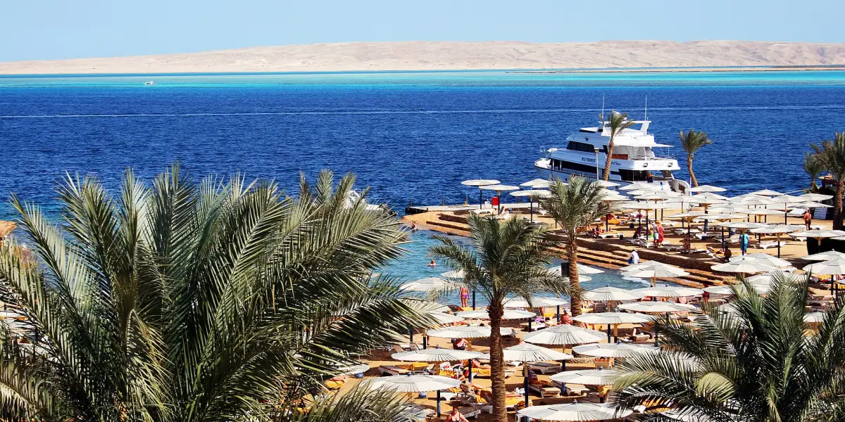 Beach with a small marina and turquoise water in Hurghada